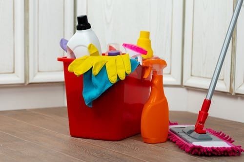 Cleaning bucket and mop in a bright kitchen, illustrating practical cleaning guides