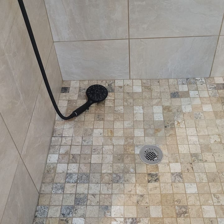 Mosaic-tile shower floor and drain after a deep clean