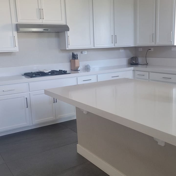 Kitchen island and gas cooktop wiped down after cleaning
