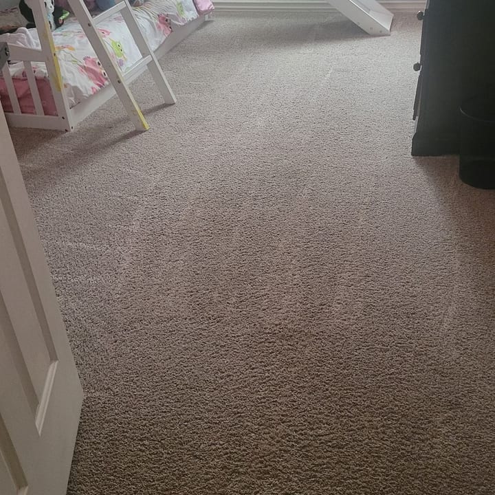 Freshly vacuumed bedroom carpet showing clean vacuum lines