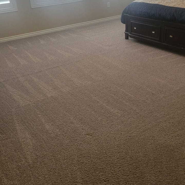 Vacuumed carpet beside a bed in a Las Vegas bedroom