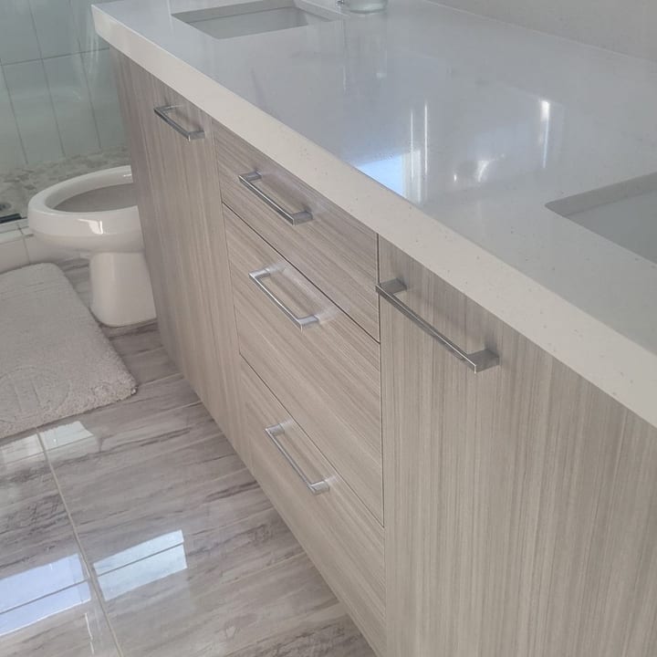 Double-sink bathroom vanity with a polished countertop after cleaning