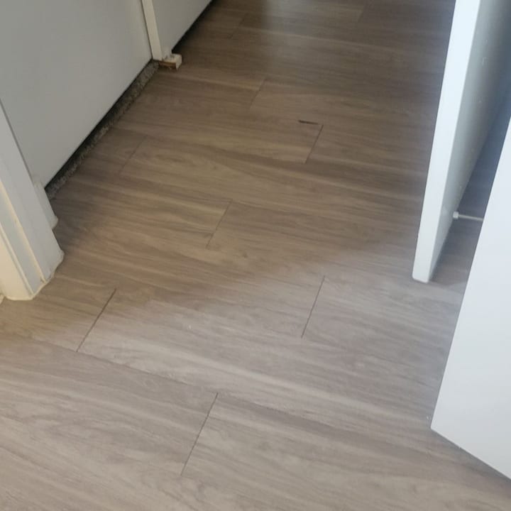 Wood-look tile hallway floor mopped and dry after cleaning