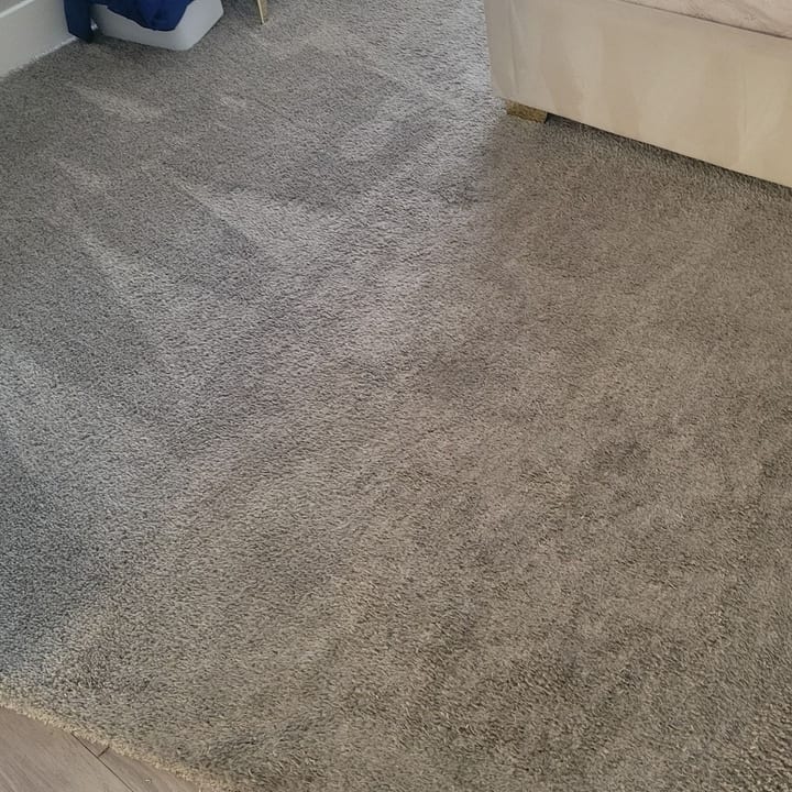 Bedroom carpet vacuumed clean after tidying