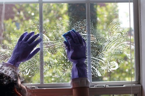 Cleaner washing the inside of a large residential window during interior window cleaning in Las Vegas